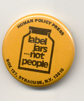 Yellow pin-button with a drawing on a jar in black marked "Label Jars ... Not People" and the Human Policy Press address