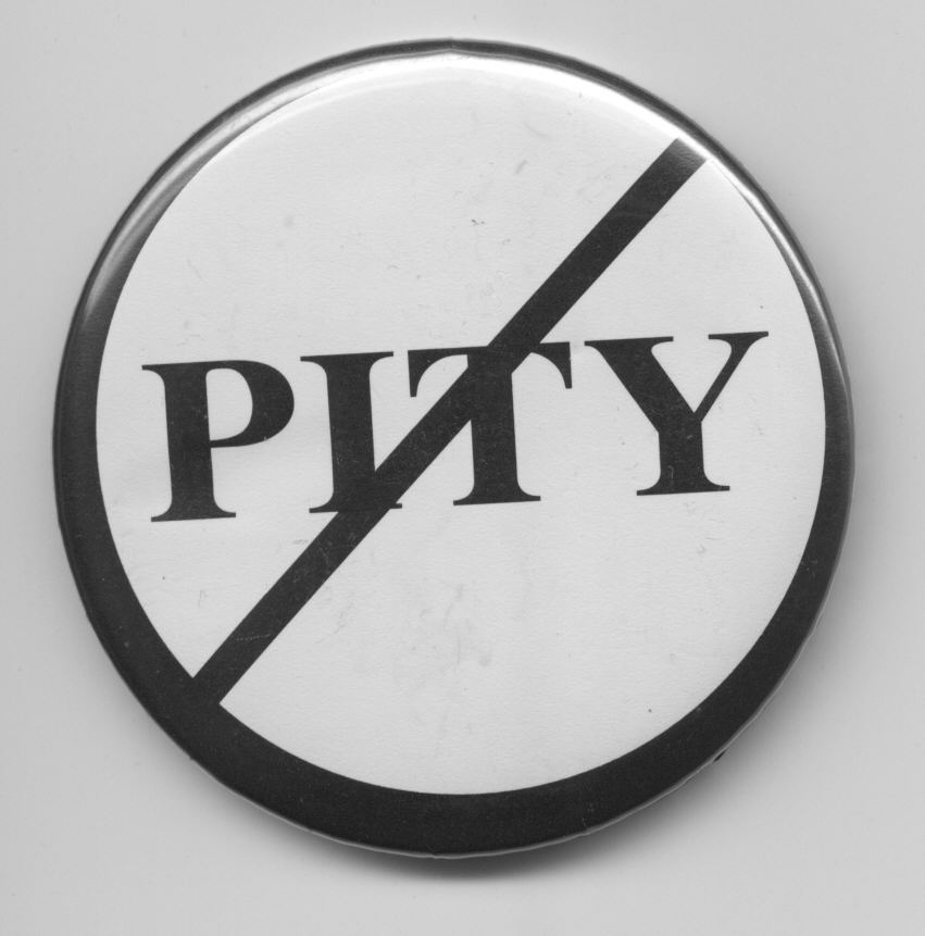 White pin-button printed "Pity" in black, with a black circle around it and a black line through it